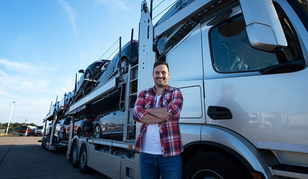 professional driver standing by truck